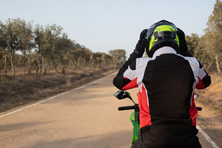 Rider adjusting helmet on motorcycle route in Victoria in Australia