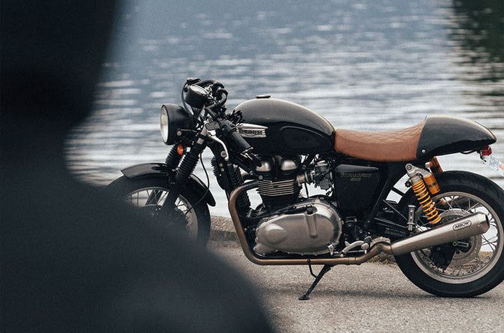 Motorcycle parked in front of water 