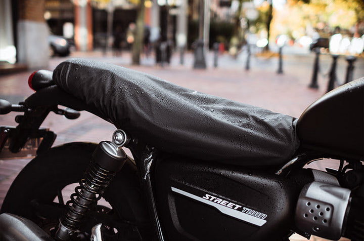 Black Street Twin Motorcycle parked on the sidewalk 