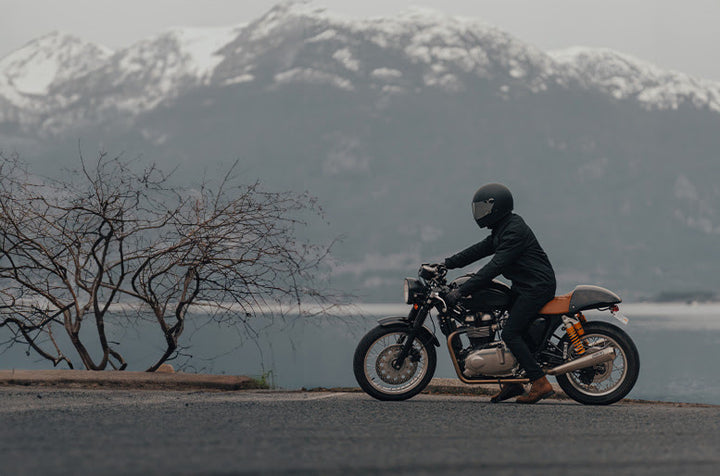 Person riding motorcycle through British Columbia mountains