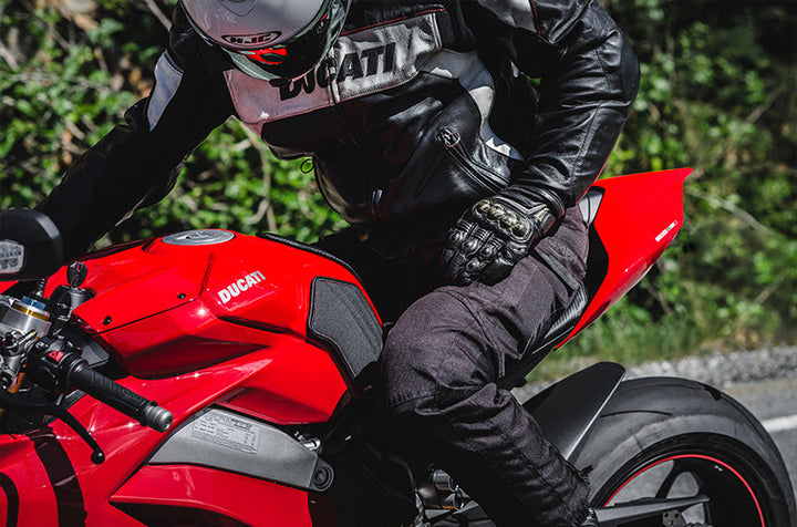 Rider on Ducati with Luimoto tank grips demonstrating improved grip