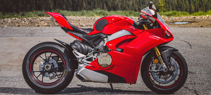 Tank Grips banner image with a red Ducati motorcycle